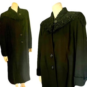 May include: A long black coat with a large, fluffy black fur collar. The coat has a button closure and long sleeves.