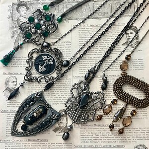 May include: A collection of vintage necklaces with black, silver, and green beads. The necklaces are displayed on a page from an old book with text about "Women's Chances as Bread-Winners".
