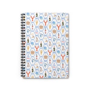 May include: Spiral-bound notebook featuring a repeating pattern of nautical and beach-themed illustrations. The design includes lobsters, ice cream cones, sailboats, and champagne bottles, all set against a blue and white trellis background.