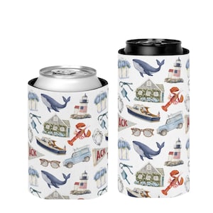 May include: Two white can coolers with a nautical pattern. The pattern includes a blue whale, a lighthouse with an American flag, a lobster, a boat, a house, sunglasses, and a blue car. The word "ACK" is also printed on the coolers.