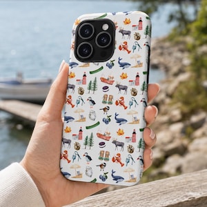 May include: A white smartphone case featuring a repeating watercolor pattern of coastal and woodland elements including lighthouses, moose, whales, puffins, lobsters, pine trees, autumn leaves, blueberries, fishing boats, and hiking boots.