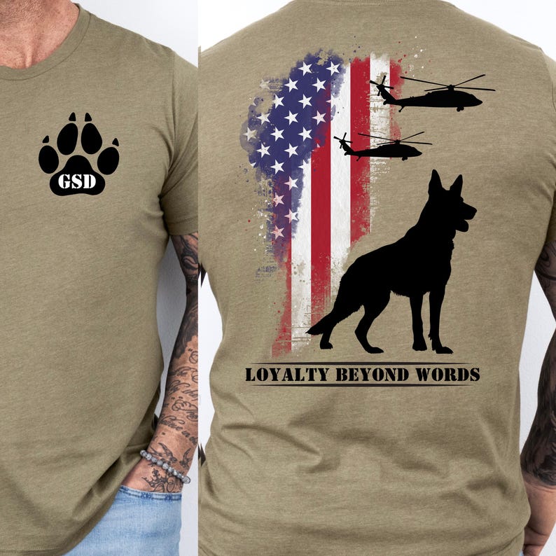 May include: Khaki green t-shirt with a black paw print and "GSD" on the front. The back displays a black German Shepherd silhouette, American flag, and two helicopters. The text "LOYALTY BEYOND WORDS" is below the dog.