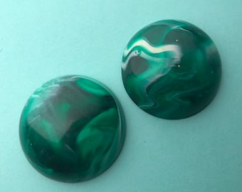 May include: Two round, green and white marbled cabochons. The cabochons have a swirling pattern of green and white.