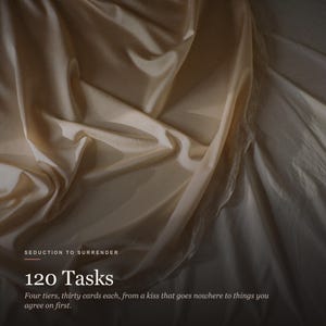 May include: A set of 120 cards titled Seduction to Surrender, organized into four tiers of thirty cards each. The text describes tasks ranging from a kiss that goes nowhere to things you agree on first, set against a draped, cream-colored fabric.