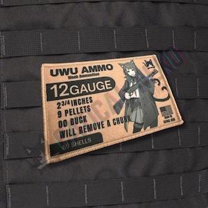 May include: A rectangular patch with the text "UWU AMMO" and "12 GAUGE". The patch features an anime-style character holding a rifle. The text includes "2 3/4 INCHES", "9 PELLETS", "00 BUCK", "WILL REMOVE A CHUNK", and "69 SHELLS".