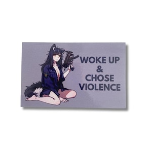 Op de afbeelding: Een rechthoekige sticker met een anime-stijl karakter met wolvenoren en een staart, die een pistool vasthoudt. Het karakter draagt een donkerblauwe jas. De tekst "WOKE UP & CHOSE VIOLENCE" is in donkergrijs gedrukt.