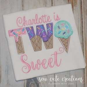 May include: A white t-shirt with pink embroidery that says "Charlotte is TWO Sweet" with the number two made to look like ice cream cones with sprinkles and melted chocolate.