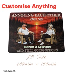 May include: A rectangular sign measuring 200mm x 150mm featuring a sunset lake scene with two people in wooden chairs. Text reads: ANNOYING EACH OTHER SINCE 1992, Martin & Lorraine, AND STILL GOING STRONG. The design includes a forest background.