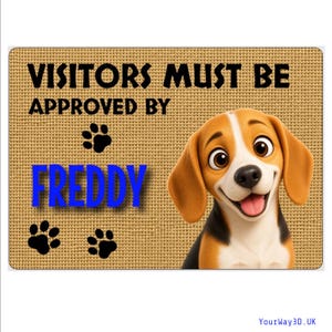 May include: A rectangular tan doormat with a textured surface featuring the black text "VISITORS MUST BE APPROVED BY" and the blue text "FREDDY". The mat includes three black paw prints and a cartoon illustration of a beagle dog on the right side.