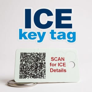 May include: A white key tag with a QR code and the text "SCAN for ICE Details" in red. The tag has a hole for a keyring and is attached to a silver ring. Above the tag is a sticker that says "ICE key tag" in blue.