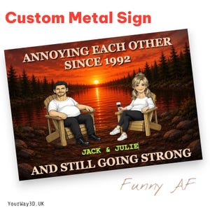 May include: A rectangular metal sign featuring a sunset lake scene with two cartoon figures sitting in wooden chairs. The text reads: ANNOYING EACH OTHER SINCE 1992, JACK & JULIE, AND STILL GOING STRONG. The figures are dressed in casual clothing.