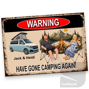May include: A rectangular metal sign with a distressed border featuring a red oval with the text WARNING. It displays a light blue and white camper van, a cartoon illustration of two people sitting in folding chairs by a campfire, and the text Jack & Heidi HAVE GONE CAMPING AGAIN!