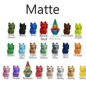 May include: A collection of 18 lucky cat figurines in various colours, including army green, black, blue, brick red, candy rainbow, chocolate, grass green, green, light blue, light brown, light green, light grey, navy blue, orange, pink, purple, rainbow, red, skin, white, wood, and yellow. The figurines are all in a matte finish.
