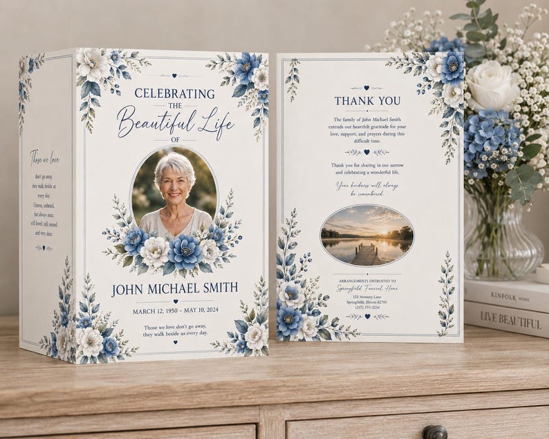May include: A memorial card with a photo of a woman, surrounded by blue and white floral accents. The text reads "Celebrating the Beautiful Life of John Michael Smith, March 12, 1950 - May 10, 2024." The card is open, revealing a thank you message.