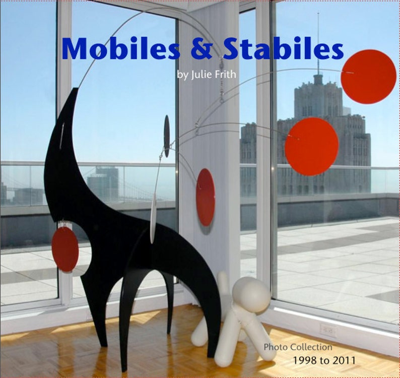 May include: A black and white abstract sculpture with red circles hanging from a wire mobile. The sculpture is in a room with large windows and a view of a city skyline. The text "Mobiles & Stables by Julie Frith" is at the top of the image. The text "Photo Collection 1998 to 2011" is at the bottom of the image.