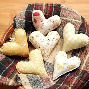 Six hearts that are 2 and 1/4th inches in this set.
Great gift for a Rooster lover.
  In shades of beige, white, red and tan these have a Rooster, chickens, chicken scratches, sunrises and baby chicks on them.