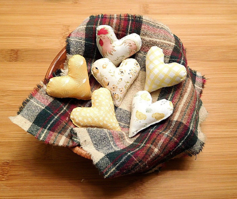Six hearts that are 2 and 1/4th inches in this set.
Great gift for a Rooster lover.
  In shades of beige, white, red and tan these have a Rooster, chickens, chicken scratches, sunrises and baby chicks on them.