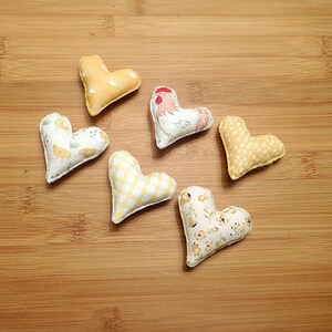 Six hearts that are 2 and 1/4th inches in this set.
Great gift for a Rooster lover.
  In shades of beige, white, red and tan these have a Rooster, chickens, chicken scratches, sunrises and baby chicks on them.