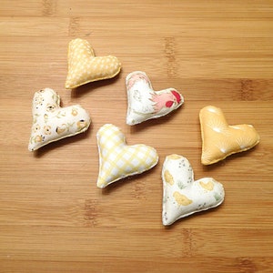 Six hearts that are 2 and 1/4th inches in this set.
Great gift for a Rooster lover.
  In shades of beige, white, red and tan these have a Rooster, chickens, chicken scratches, sunrises and baby chicks on them.