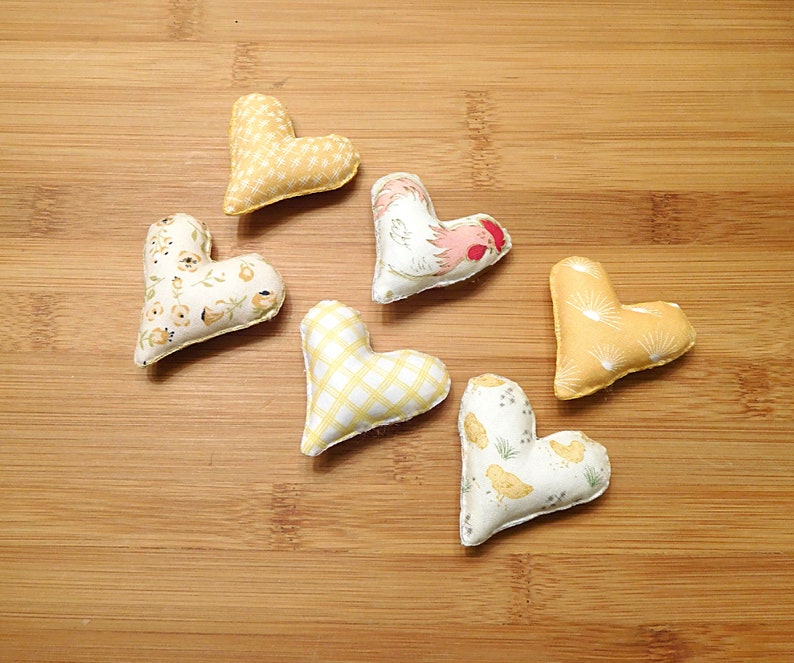 Six hearts that are 2 and 1/4th inches in this set.
Great gift for a Rooster lover.
  In shades of beige, white, red and tan these have a Rooster, chickens, chicken scratches, sunrises and baby chicks on them.