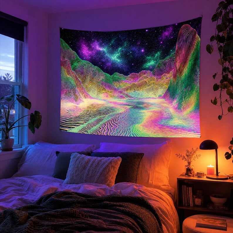 May include: A vibrant tapestry depicting a colorful, abstract landscape with mountains, a river, and a starry night sky. The artwork features a spectrum of colors, including pink, green, yellow, and purple, creating a psychedelic effect. The tapestry is hanging above a bed.