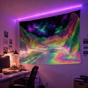 May include: A vibrant tapestry featuring a psychedelic landscape with mountains, a river, and a starry night sky. The artwork uses a spectrum of colors, including green, yellow, pink, and purple. The tapestry is hanging on a wall, illuminated by a purple LED light strip.