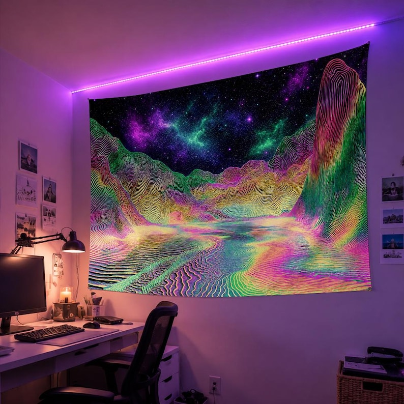 May include: A vibrant tapestry featuring a psychedelic landscape with mountains, a river, and a starry night sky. The artwork uses a spectrum of colors, including green, yellow, pink, and purple. The tapestry is hanging on a wall, illuminated by a purple LED light strip.