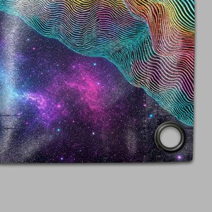 May include: A fabric panel featuring a vibrant depiction of a nebula and a starry galaxy. The design incorporates a gradient of colors, including blues, purples, and pinks, with a textured, wavy pattern in the upper right corner. A grommet is visible in the lower right corner.