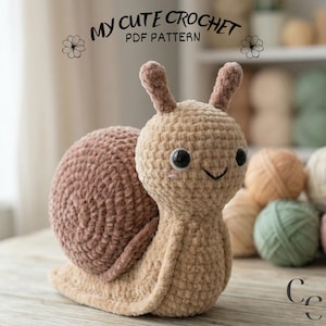 May include: A crocheted snail toy, featuring a tan body and a mauve shell. The snail has large black eyes, rosy cheeks, and a smiling mouth. The text "MY CUTE CROCHET PDF PATTERN" is above the snail.