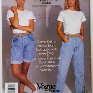 May include: A Vogue Patterns sewing pattern envelope for Calvin Klein Jeans, number 2851, dated 1991. The cover features two views of light blue denim jeans, one as shorts and one as long pants, paired with a white t-shirt and a tan belt.