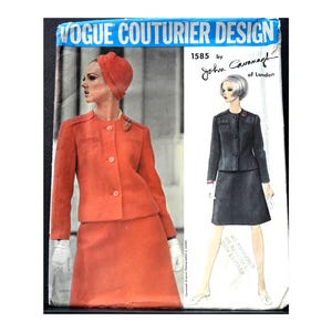 May include: Vintage Vogue Couturier Design sewing pattern featuring a red skirt suit and a black skirt suit. The pattern is by John Cavanagh of London. The text "VOGUE COUTURIER DESIGN" is at the top.