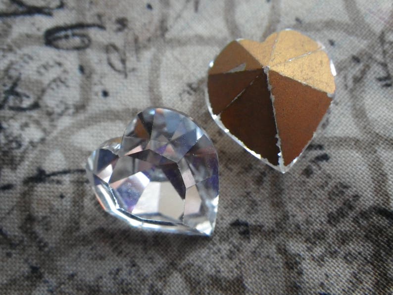 May include: Two heart-shaped embellishments, one clear glass and one gold foil.
