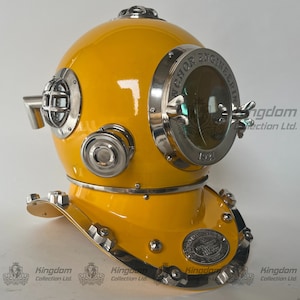 May include: A yellow diving helmet with a silver viewport and a silver plaque that reads "Anchor Engineering 1971".