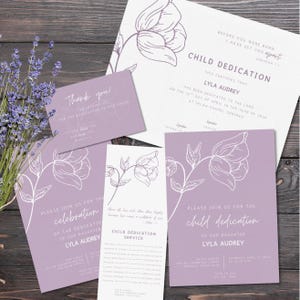 May include: A selection of lilac stationery featuring floral illustrations. The set comprises invitations, thank you cards, and a child dedication certificate. The text includes the name "Lyla Audrey" and event details.