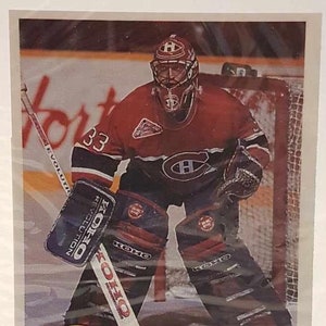 May include: A hockey trading card featuring Patrick Roy, a goalie for the Montreal Canadiens, during the 1992-93 season. The card is part of the "Greatest Goalies" series and features a photo of Roy in action, wearing his red and blue Canadiens jersey and goalie equipment. The card also includes the text "Patrick Roy" and "Montreal Canadiens 1992-93".