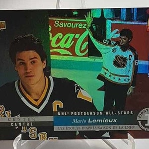 May include: A hockey trading card featuring Mario Lemieux, a centre for the Pittsburgh Penguins, in a black and yellow jersey. The card is from the 1993-94 Upper Deck NHL Postseason All-Stars set. The card is numbered 1 and features a Coca-Cola advertisement in the background.