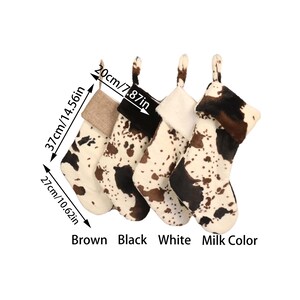 May include: Four Christmas stockings with a cow print design. The stockings are brown, black, white, and milk color. The stockings are 14.56 inches tall and 10.62 inches wide.