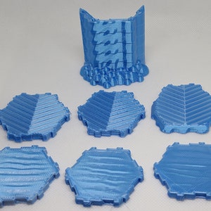 Könnte beinhalten: Sechs hellblaue sechseckige Fliesen mit einer strukturierten Oberfläche und ein hellblauer Wandabschnitt mit einer strukturierten Oberfläche.