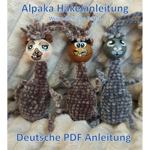 May include: Three handmade plush toys with painted faces and fuzzy bodies. The toys are in shades of brown and grey, with the text "Alpaka Häkelanleitung" and "Deutsche PDF Anleitung" visible.