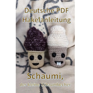 May include: Two crocheted ice cream cone toys with smiling faces. One has a dark purple top, the other a white top. The text "Deutsche PDF Häkelanleitung" and "Schaumi, der kleine Schaumbecher" are visible.