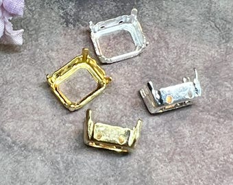 May include: Four metal jewelry settings for gemstones, including two square silver-tone frames and two rectangular gold-tone frames. Each setting features four small prongs at the corners to secure a stone, with open centers and smooth metallic finishes.