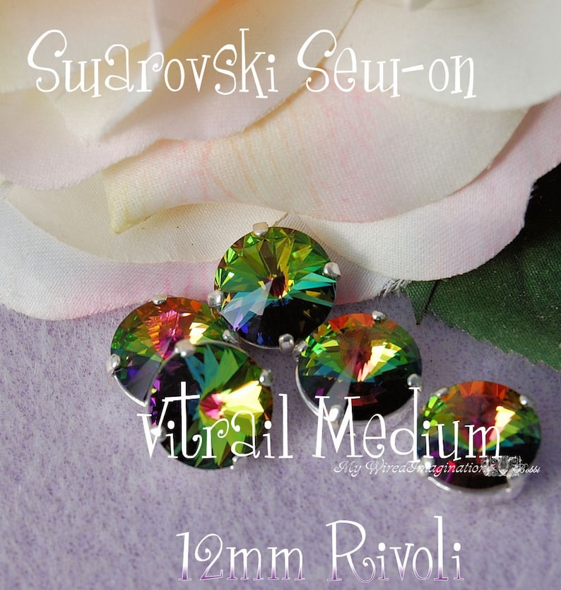 May include: Five iridescent Swarovski sew-on crystals, 12mm rivoli, with a silver setting. The crystals have a vibrant color shift from green to purple. Text on the image reads "Swarovski Sew-on", "Vitrail Medium", and "12mm Rivoli".
