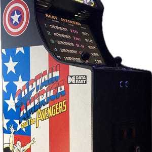 May include: A vintage arcade cabinet with a Captain America and the Avengers theme. The cabinet is black with a red, white, and blue American flag design. The game screen shows the high scores for the game.