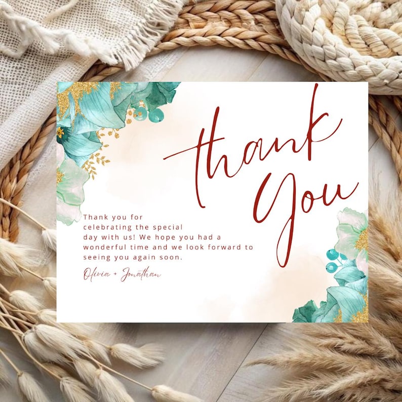May include: Thank you card with a watercolor floral design in shades of teal and gold. The text "Thank You" is written in large, bold, red script. The card includes the text "Thank you for celebrating the special day with us! We hope you had a wonderful time and we look forward to seeing you again soon. Olivia & Jonathan."