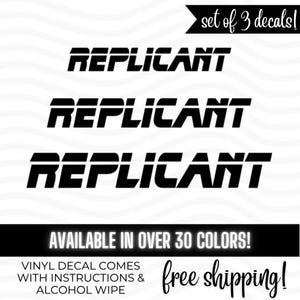 May include: Set of three black vinyl decals with the word "REPLICANT" in a bold, futuristic font. The decals are displayed on a white background. The text "AVAILABLE IN OVER 30 COLORS!" is also present.