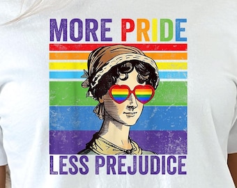 Könnte beinhalten: Weißes T-Shirt mit einem Regenbogen-Motiv und dem Text "More Pride Less Prejudice". Das Motiv zeigt eine Frau mit Regenbogen-Herz-Sonnenbrillen.