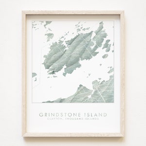 May include: A framed print of a map of Grindstone Island, Clayton, Thousand Islands. The map is in a watercolor style with a green and white color scheme.