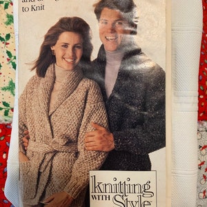 May include: A knitting pattern booklet featuring a couple wearing turtlenecks and cardigans. The cover reads "Knitting with Style from Simplicity" and "Turtlenecks and Cardigans to Knit".