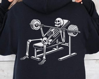 Sudadera con capucha de gimnasio Swoll Skelly: gráfico de esqueleto de levantamiento de pesas