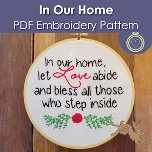 May include: An embroidery hoop featuring the words "In our home, let Love abide and bless all those who step inside." The word "Love" is in red cursive. The design includes a floral and leaf border.